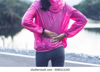 Athlete Asian Young Girl Back Injury Sprain Pain Hurt Running Exercise Fitness Healthy Lifestyle Resting Tired Wearing Casual Jogging Clothes, Morning Sunrise Outdoor Nature Mountain Lake Landscape