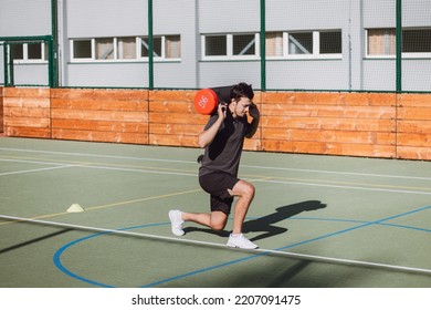 Athlete In Athletic Attire With A Barbell On His Back Performs A Lunge To Strengthen The Trunk And Lower Extremities. Strengthening The Thigh And Groin Muscles.