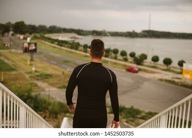 An Athlete In Black Gear Runs Down The Stairs 