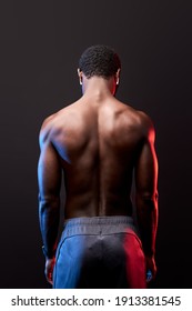 Athlete Black Man With Strong Muscular Back, Rear View. Workout, Sport Concept. Isolated Black Background