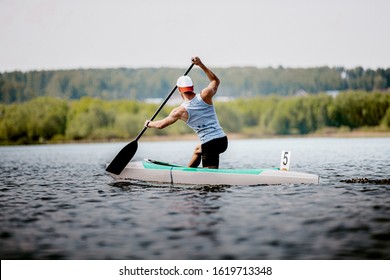 Athlete Canoeist Rowing In Lake. Canoeing Competition Race