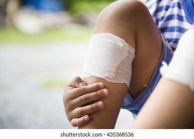 Athlete Child Injured. Child Knee With A Plaster And Bruise.