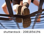 Athlete climbs the net, climbing net in an obstacle course. Look from below