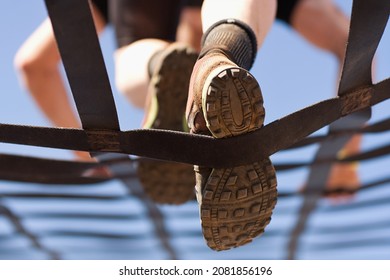 Athlete climbs the net, climbing net in an obstacle course. Look from below - Powered by Shutterstock