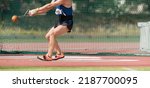 An athlete competing in the hammer throw event, athlete performing a hammer throw in stadium