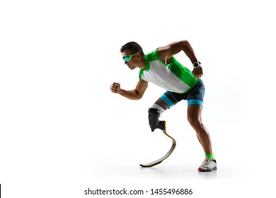 Athlete With Disabilities Or Amputee Isolated On White Studio Background. Professional Male Runner With Leg Prosthesis Training And Practicing In Studio. Disabled Sport And Healthy Lifestyle Concept.