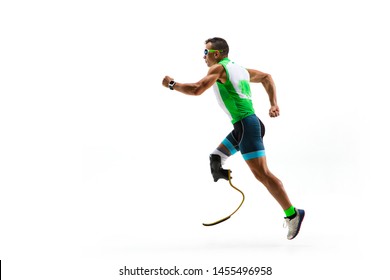 Athlete With Disabilities Or Amputee Isolated On White Studio Background. Professional Male Runner With Leg Prosthesis Training And Practicing In Studio. Disabled Sport And Healthy Lifestyle Concept.