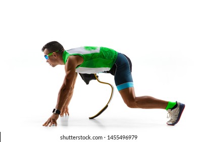 Athlete With Disabilities Or Amputee Isolated On White Studio Background. Professional Male Runner With Leg Prosthesis Training And Practicing In Studio. Disabled Sport And Healthy Lifestyle Concept.