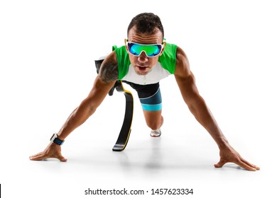 Athlete With Disabilities Or Amputee Isolated On White Studio Background. Professional Male Runner With Leg Prosthesis Training And Practicing In Studio. Disabled Sport And Healthy Lifestyle Concept.