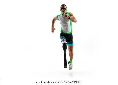 Athlete With Disabilities Or Amputee Isolated On White Studio Background. Professional Male Runner With Leg Prosthesis Training And Practicing In Studio. Disabled Sport And Healthy Lifestyle Concept.