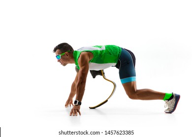 Athlete With Disabilities Or Amputee Isolated On White Studio Background. Professional Male Runner With Leg Prosthesis Training And Practicing In Studio. Disabled Sport And Healthy Lifestyle Concept.