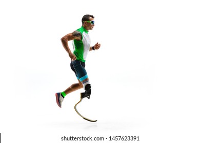 Athlete With Disabilities Or Amputee Isolated On White Studio Background. Professional Male Runner With Leg Prosthesis Training And Practicing In Studio. Disabled Sport And Healthy Lifestyle Concept.