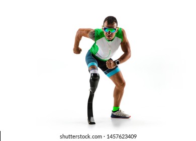 Athlete With Disabilities Or Amputee Isolated On White Studio Background. Professional Male Runner With Leg Prosthesis Training And Practicing In Studio. Disabled Sport And Healthy Lifestyle Concept.