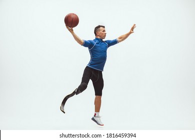 Athlete with disabilities or amputee on white studio background, basketball - Shutterstock ID 1816459394