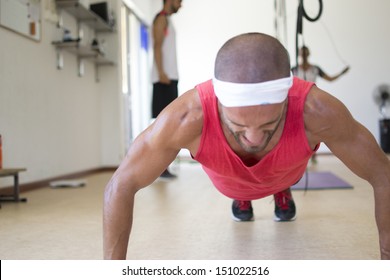 An athlete doing push ups. - Powered by Shutterstock