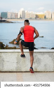 Athlete Doing Toe Taps Hiit Cardio Exercise For Warming Up Before Running. Black Young Runner Training Towards The Sea.