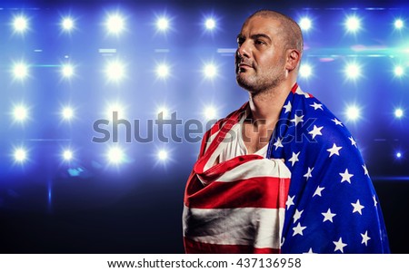 Athlete with england flag wrapped around his body against composite image of blue spotlight