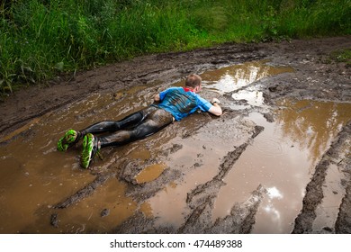 Athlete Fall Down To The Dirty Puddle In The Rural Road