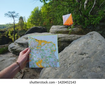 Athlete Hand Hold Typical Chart For Orienteering Sports. Person Marks The Passage Of The Control Point. Orienteering Race