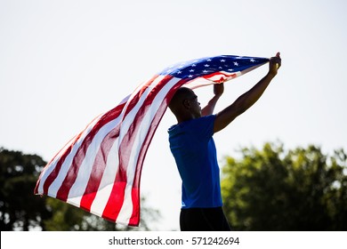 Athlete Holding An American Flag In The Air