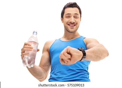 Athlete holding a bottle of water and looking at his watch isolated on white background