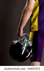 Athlete Holding Football Helmet