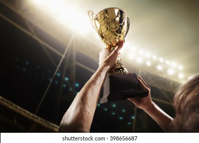 Athlete holding trophy cup - Shutterstock ID 398656687