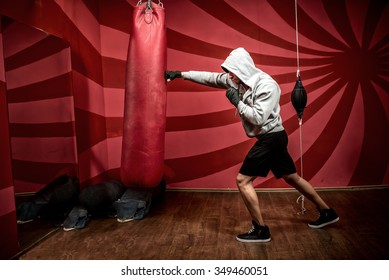 Athlete With Hoody Working Out At Boxing Gym, Getting Ready For Fight