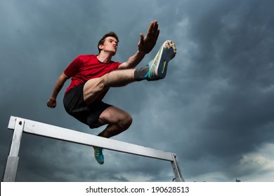 Athlete Hurdling In Track And Field