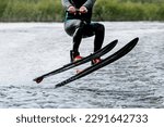 athlete jump waterskiing behind motor boat on lake, extreme summer water sports