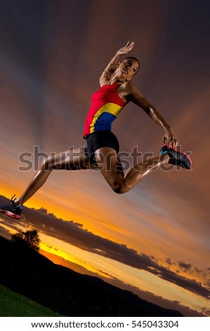 Athlete jumping against sunset