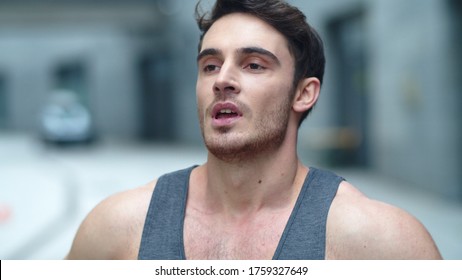 Athlete Man Resting After Fitness Workout In Slow Motion. Closeup Tired Male Runner Breathing After Marathon. Portrait Of Exhausted Sportsman After Outdoor Training.