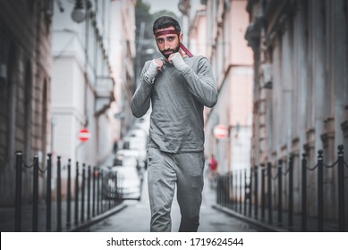 Athlete man runs through the streets of the city. Fist training from the Rocky Balboa movie.