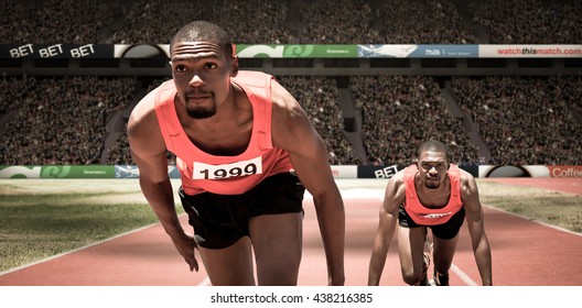 Athlete man in the starting block against athletic field in a stadium - Powered by Shutterstock