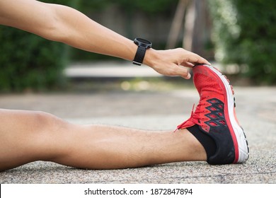 Athlete man stretching workout before practice running,or exercise to prevent muscle injury.In a Muscle inflammation concept and healthy.