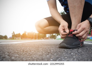 Athlete Man Tying Shoe Laces Before Starting To Run.