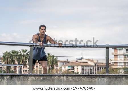 Similar – Strong Man Stretching Calf and Leaning on Wall