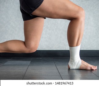 Athlete Mid Lunge With An Ankle Tape Job 