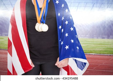 Athlete With Olympic Gold Medal Against Race Track