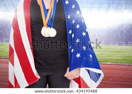 Athlete with olympic gold medal against race track