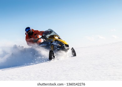 Athlete on a snowmobile moves in the winter in the mountains of the Urals.