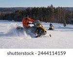 Athlete on a snowmobile moving in the winter forest in the mountains of the Southern Urals.