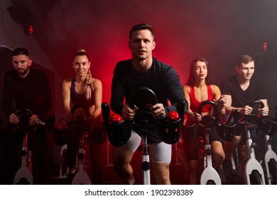 athlete people workout ride a bike in gym, with the intention of healthcare. caucasian men and women ycling to make body healthy with tight muscles and reduce the weight. male in the center - Powered by Shutterstock