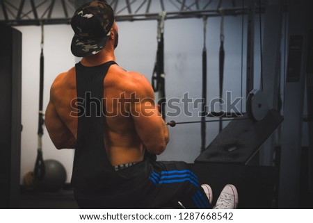 Athlete performing a cable row inside a commercial gym