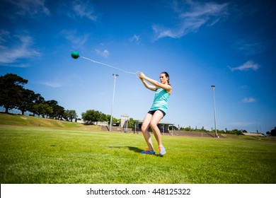 Athlete performing a hammer throw in stadium - Powered by Shutterstock