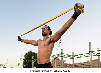 An athlete performs functional stretching with an elastic band, ideal for strength, mobility, and training without a gym.