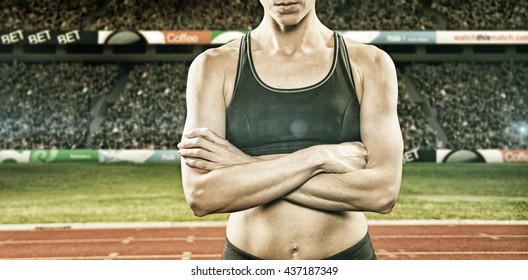 Athlete posing with arms crossed against view of a stadium - Powered by Shutterstock