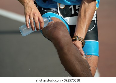 Athlete Pouring Water On Himself To Cool Down After Running