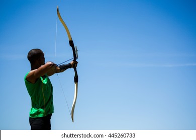 Athlete practicing archery in stadium - Powered by Shutterstock