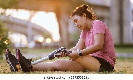 Athlete with prosthetic leg doing warm up exercise on park. Woman wearing prosthetic equipment for jogging. Female with prosthesis of leg - Powered by Shutterstock